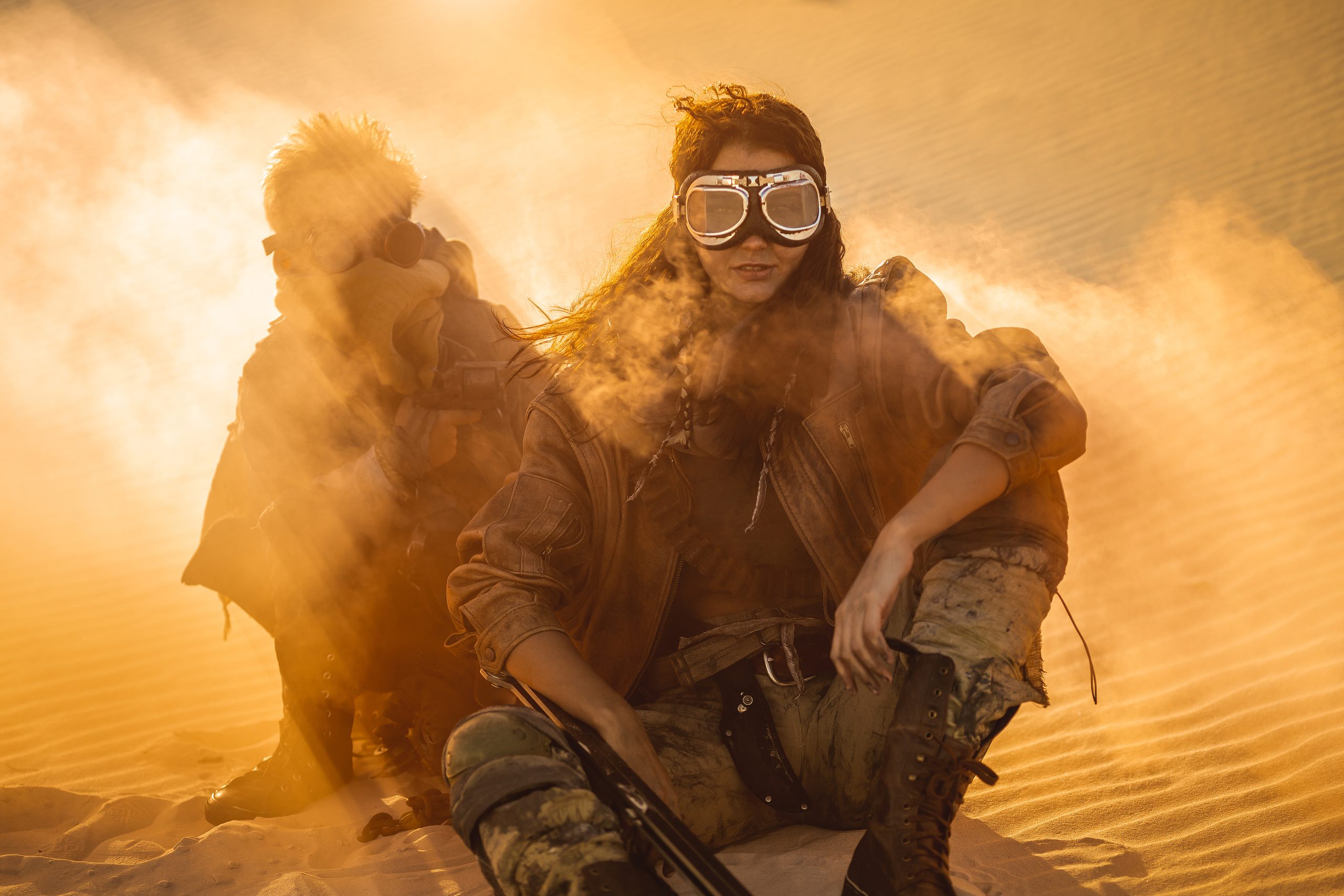 Women in mask in desert, post-apocalyptic setting.